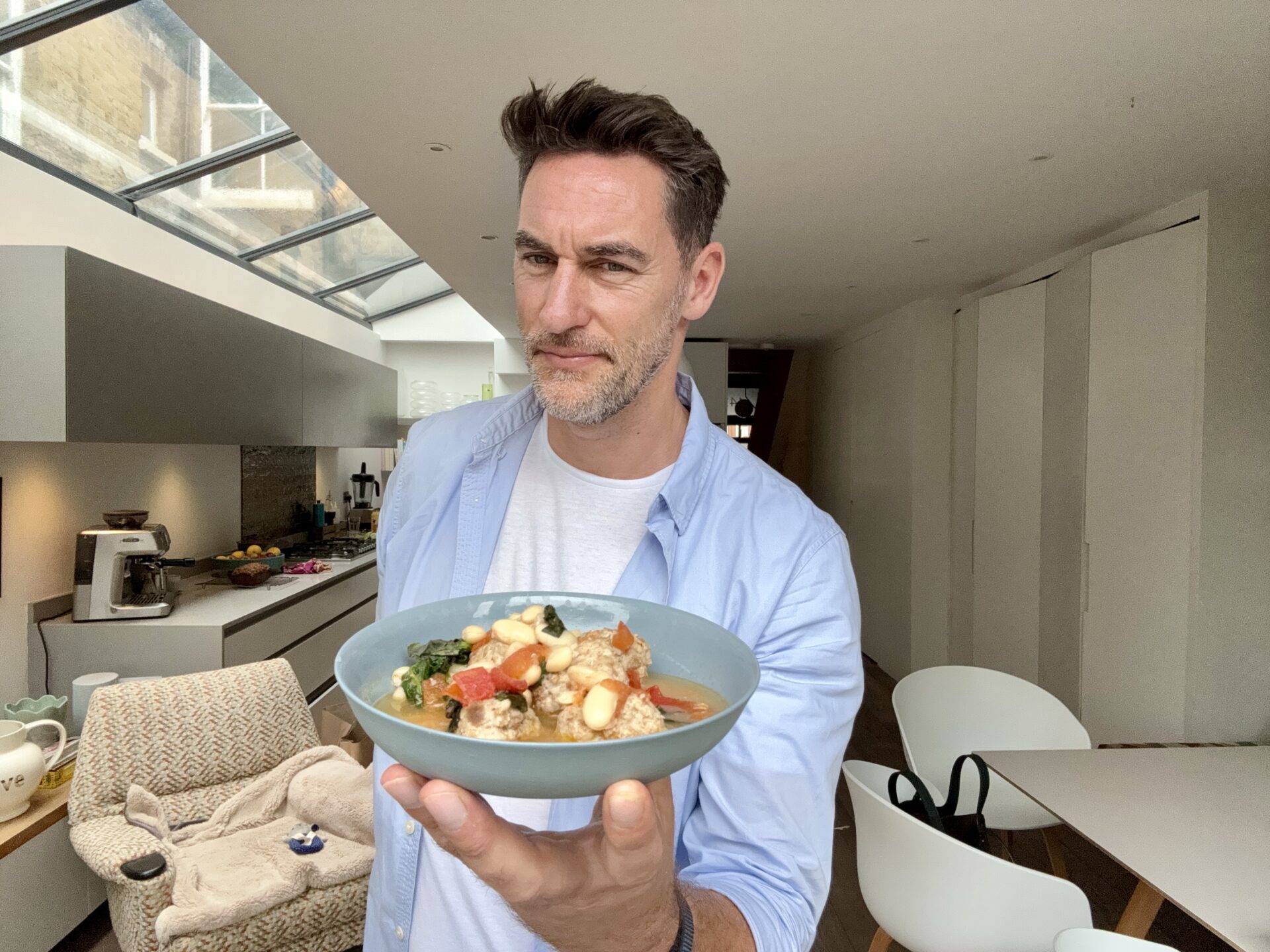 Rob Hobson, Nutritionist holding a bowl of pork meatballs with lemon and cannellini broth