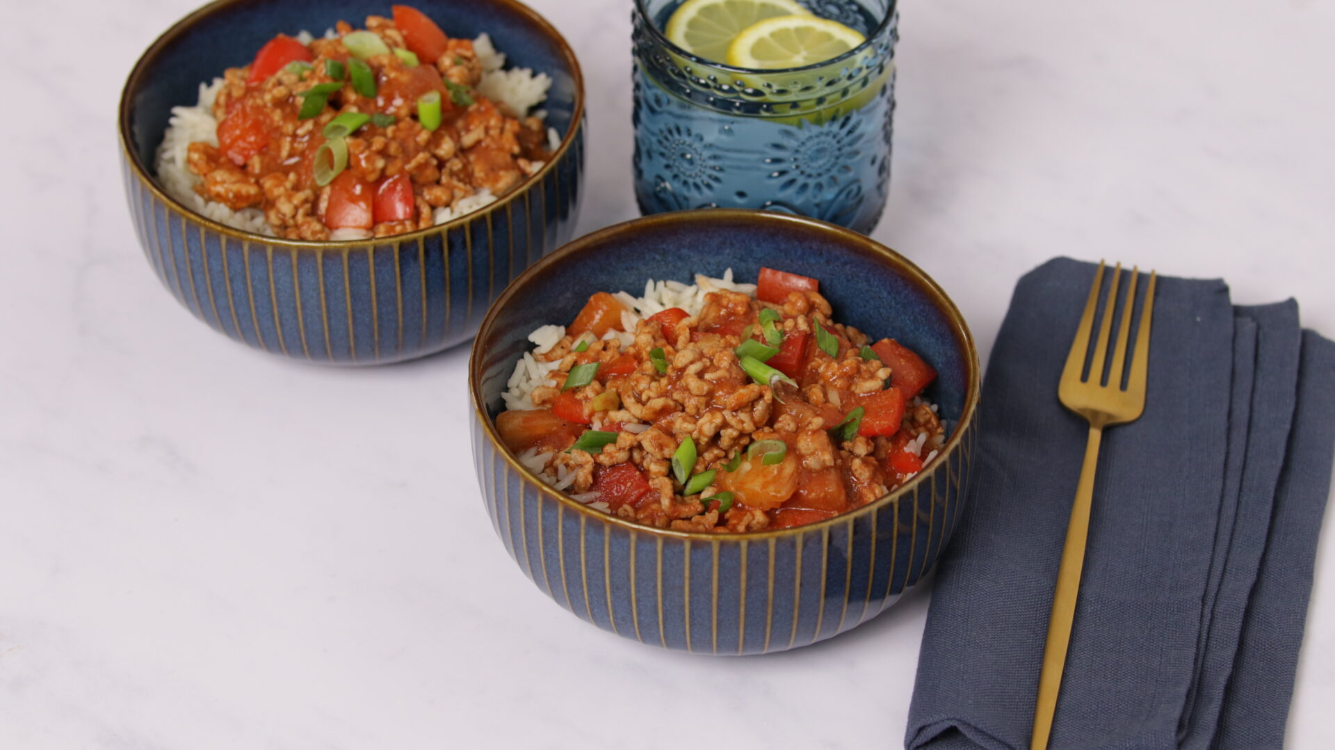 Two bowls holding pork mince and rice.