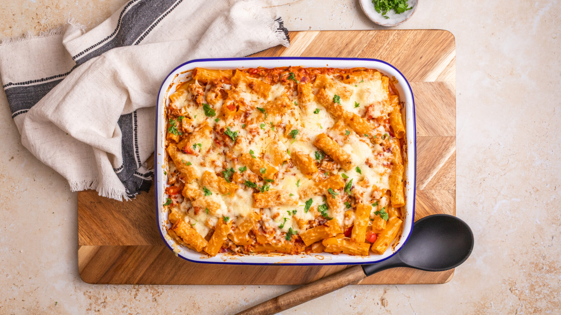 An oven dish on a table containing a Creamy Cajun Pork Pasta Bake.